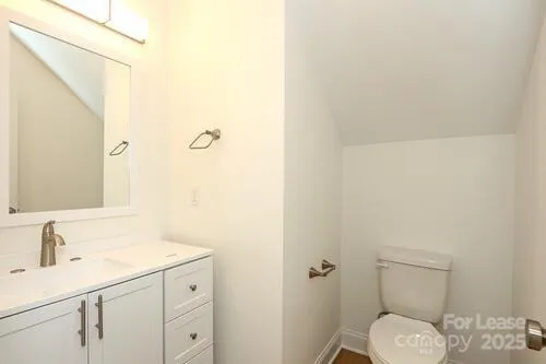 a bathroom with a sink toilet and vanity