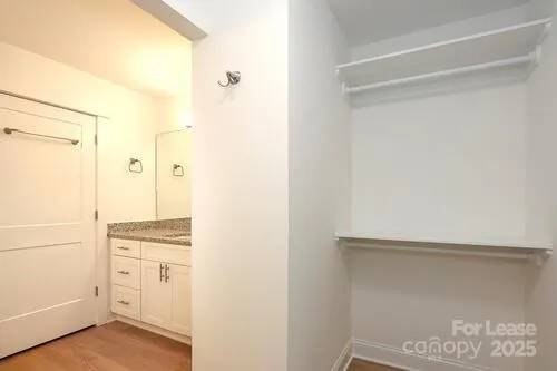 a view of walk in closet with empty racks