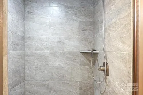 a view of a room with a window and a ceiling fan