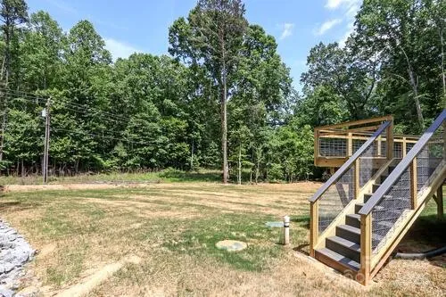 a backyard of a house with table and chairs