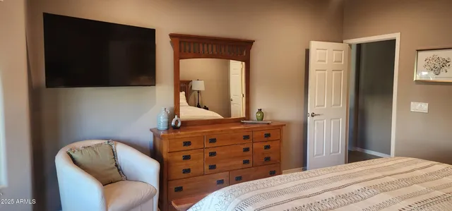 a bedroom with a bed and a television