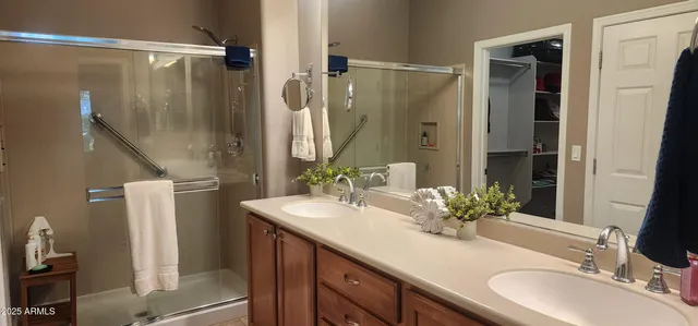 a bathroom with a double vanity sink and mirror