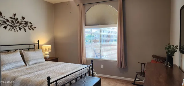 a bedroom with a bed and a potted plant