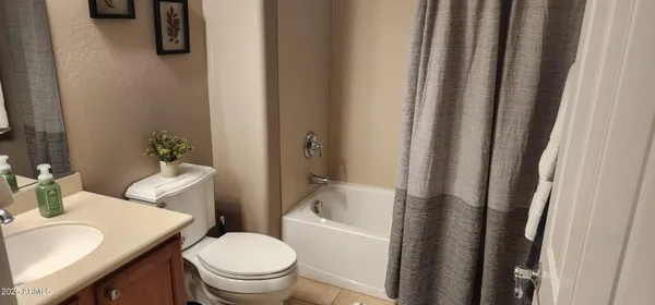 a white toilet sitting next to a bathroom sink