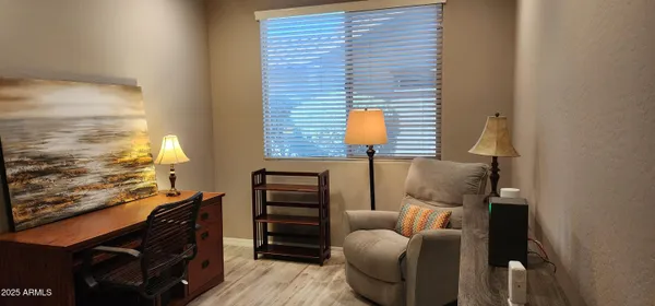 a living room with furniture and a lamp