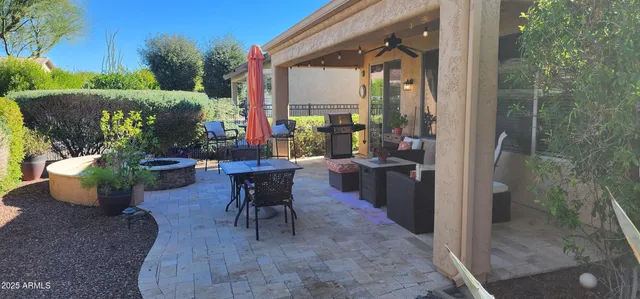 a view of a porch with chairs and potted plants