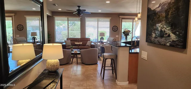 a living room with furniture and large windows