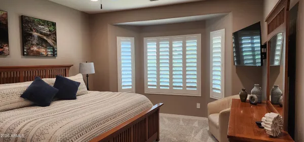a bedroom with a large bed and a window