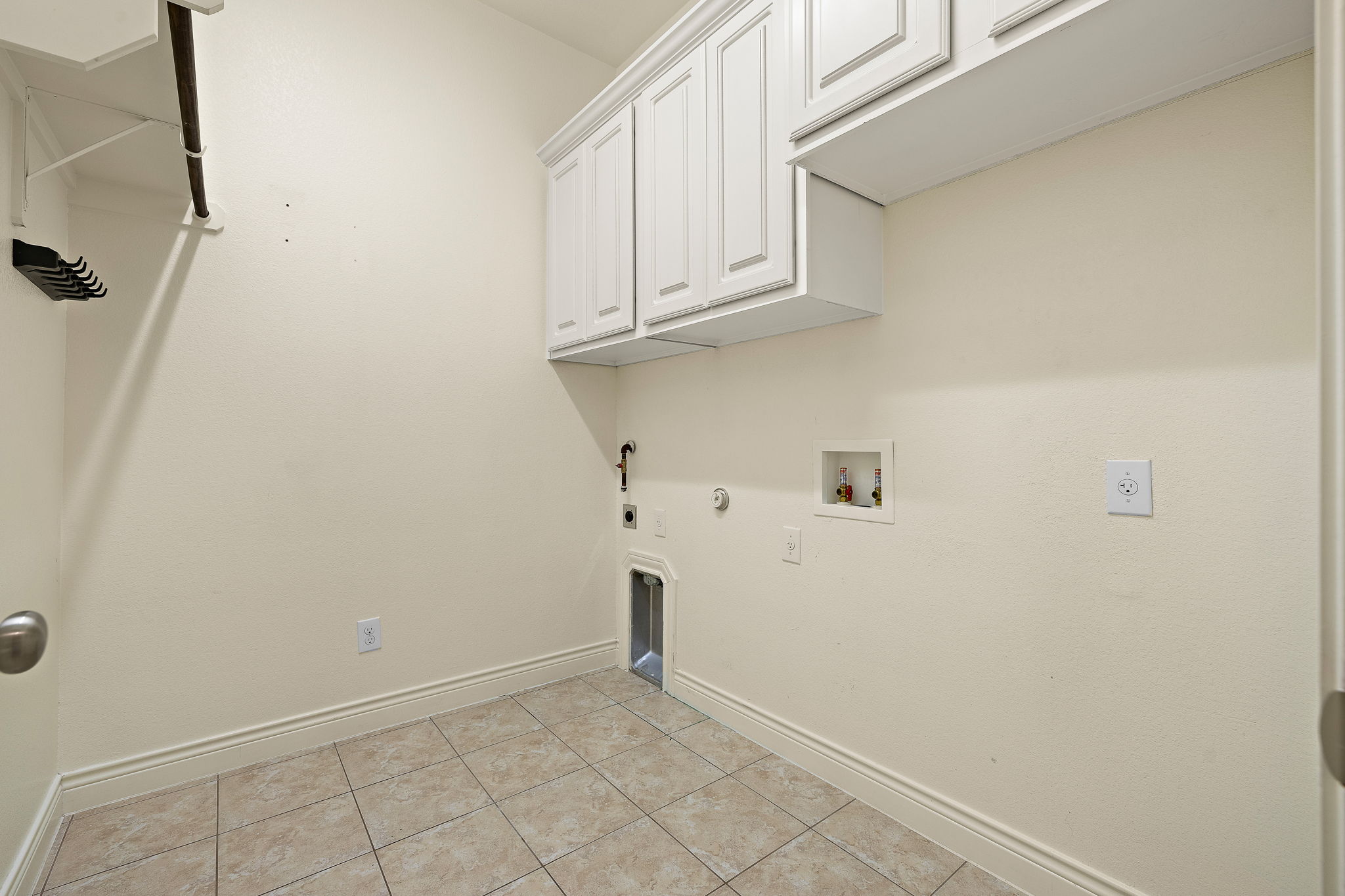 174 Estrella Crossing Georgetown, TX 78628 - Photo 29 of 38 Laundry room featuring gas dryer hookup, cabinet space, light tile patterned flooring, washer hookup, and hookup for an electric dryer