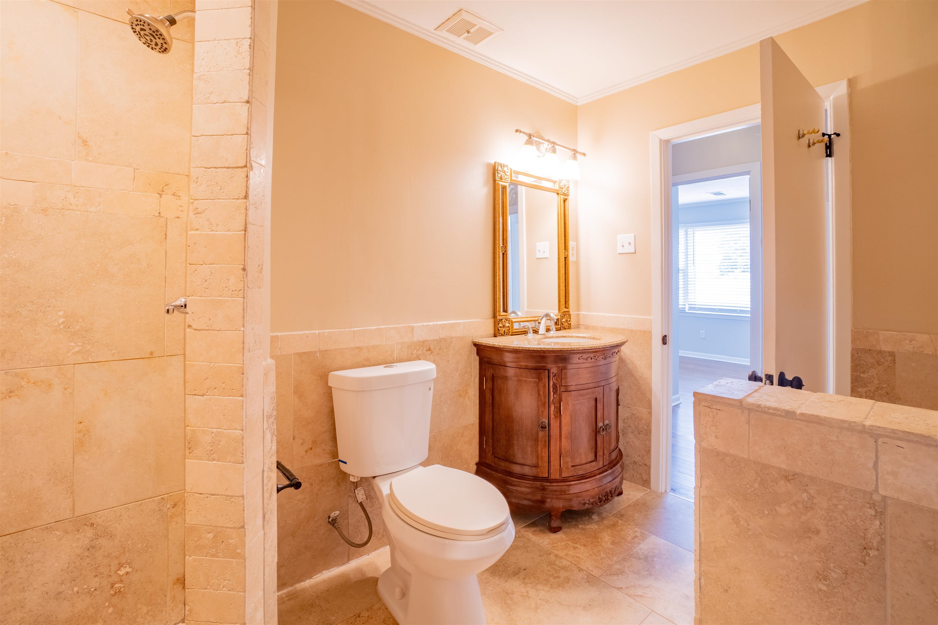 1349 Colonial Road Memphis, TN 38117 - Photo 15 of 29 a bathroom with a toilet a sink and a mirror