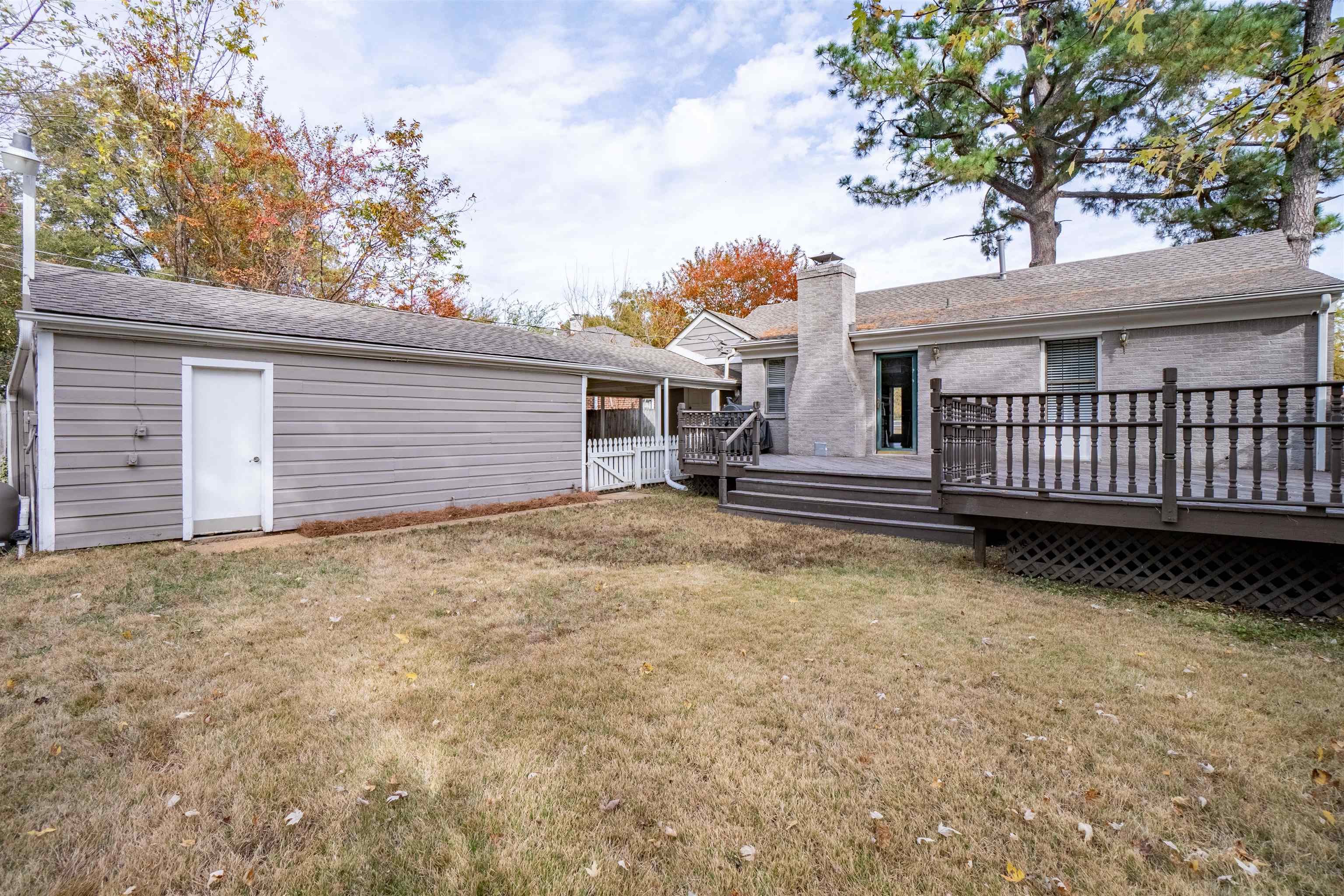 1349 Colonial Road Memphis, TN 38117 - Photo 26 of 29 a view of a house with a small yard and wooden fence