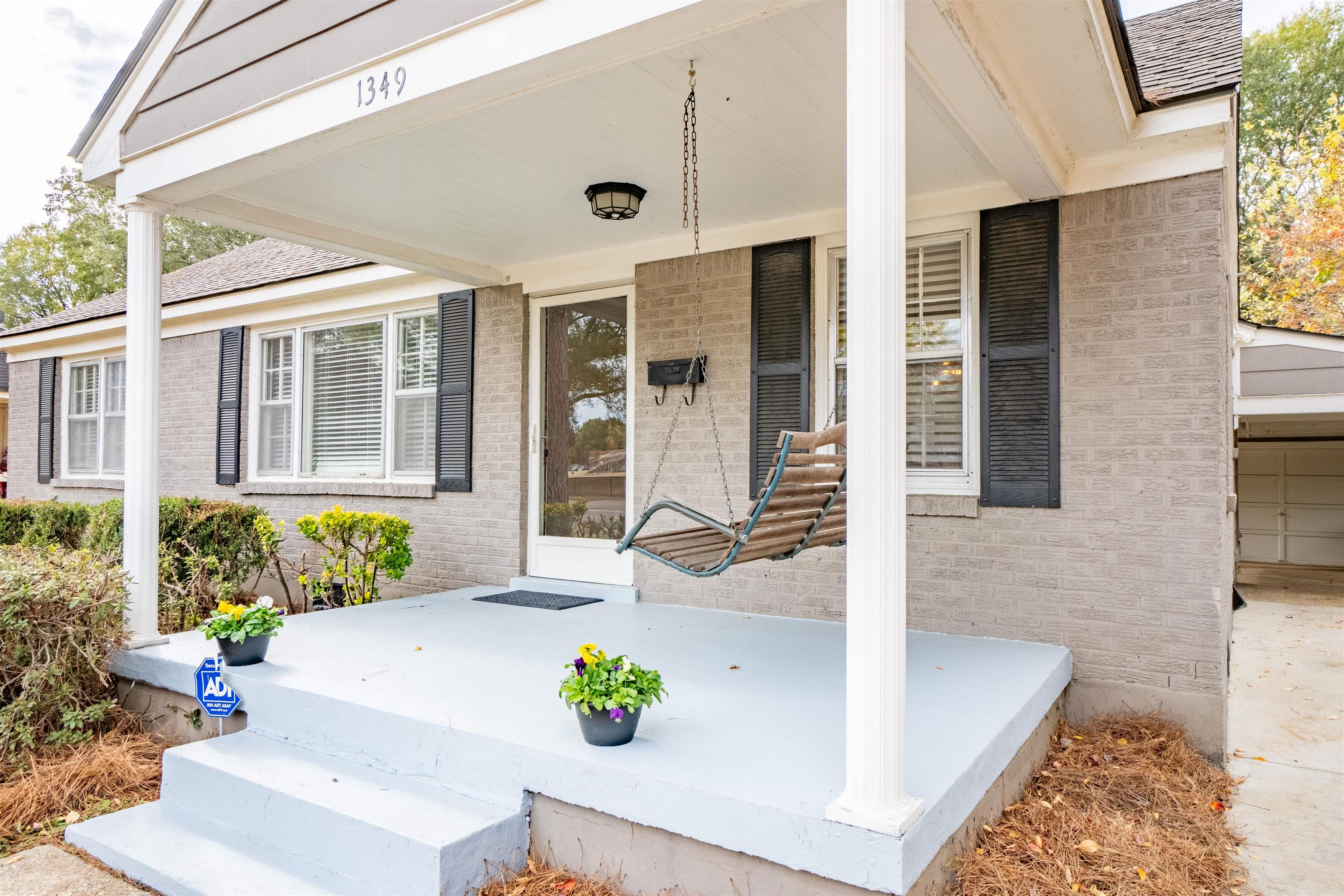 1349 Colonial Road Memphis, TN 38117 - Photo 4 of 29 a front view of a house with potted plants
