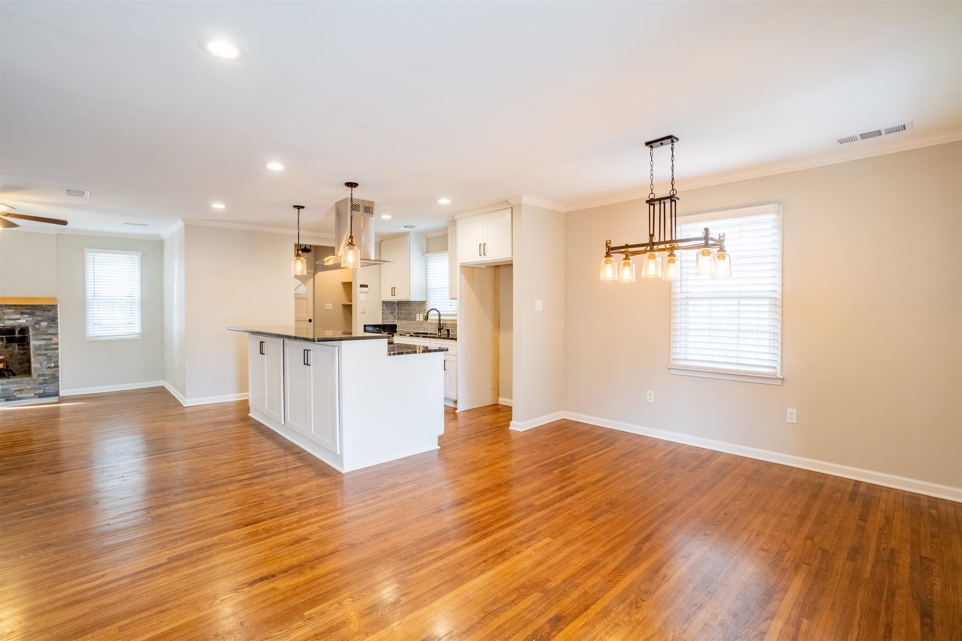 1349 Colonial Road Memphis, TN 38117 - Photo 5 of 29 a view of kitchen and empty room with wooden floor