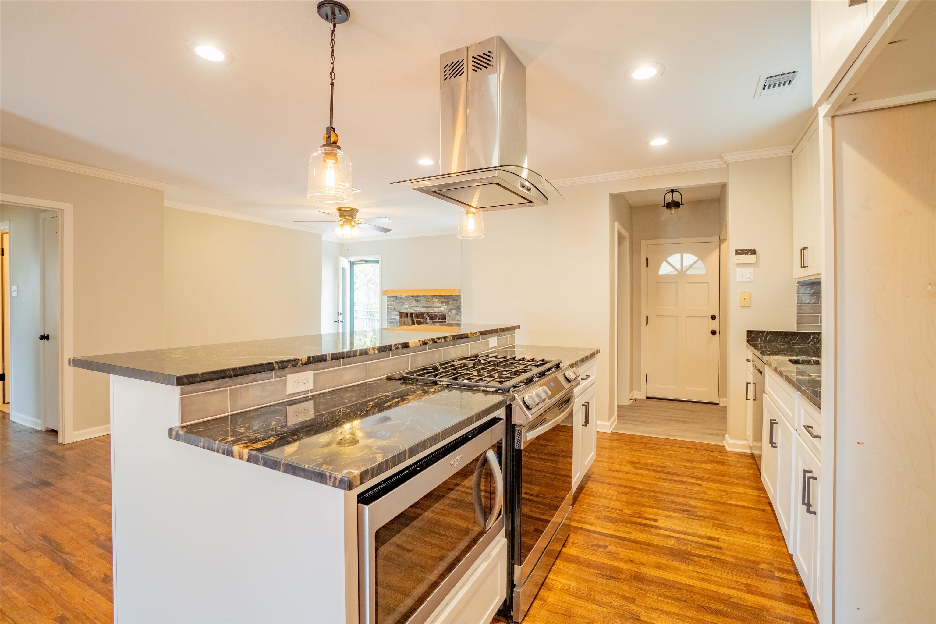 1349 Colonial Road Memphis, TN 38117 - Photo 7 of 29 a kitchen with stainless steel appliances granite countertop a stove and a sink