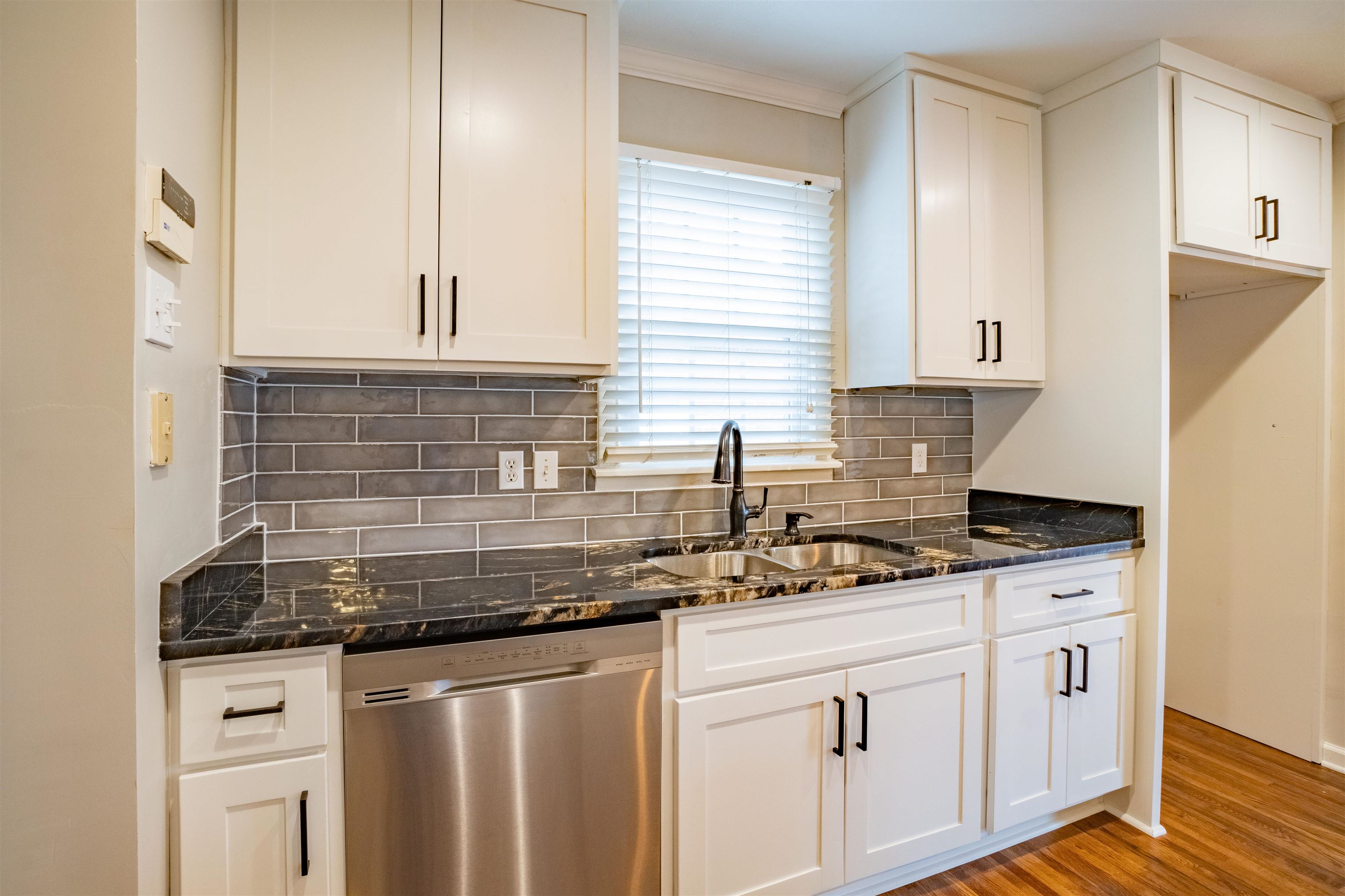 1349 Colonial Road Memphis, TN 38117 - Photo 8 of 29 a kitchen with granite countertop a sink stove and cabinets