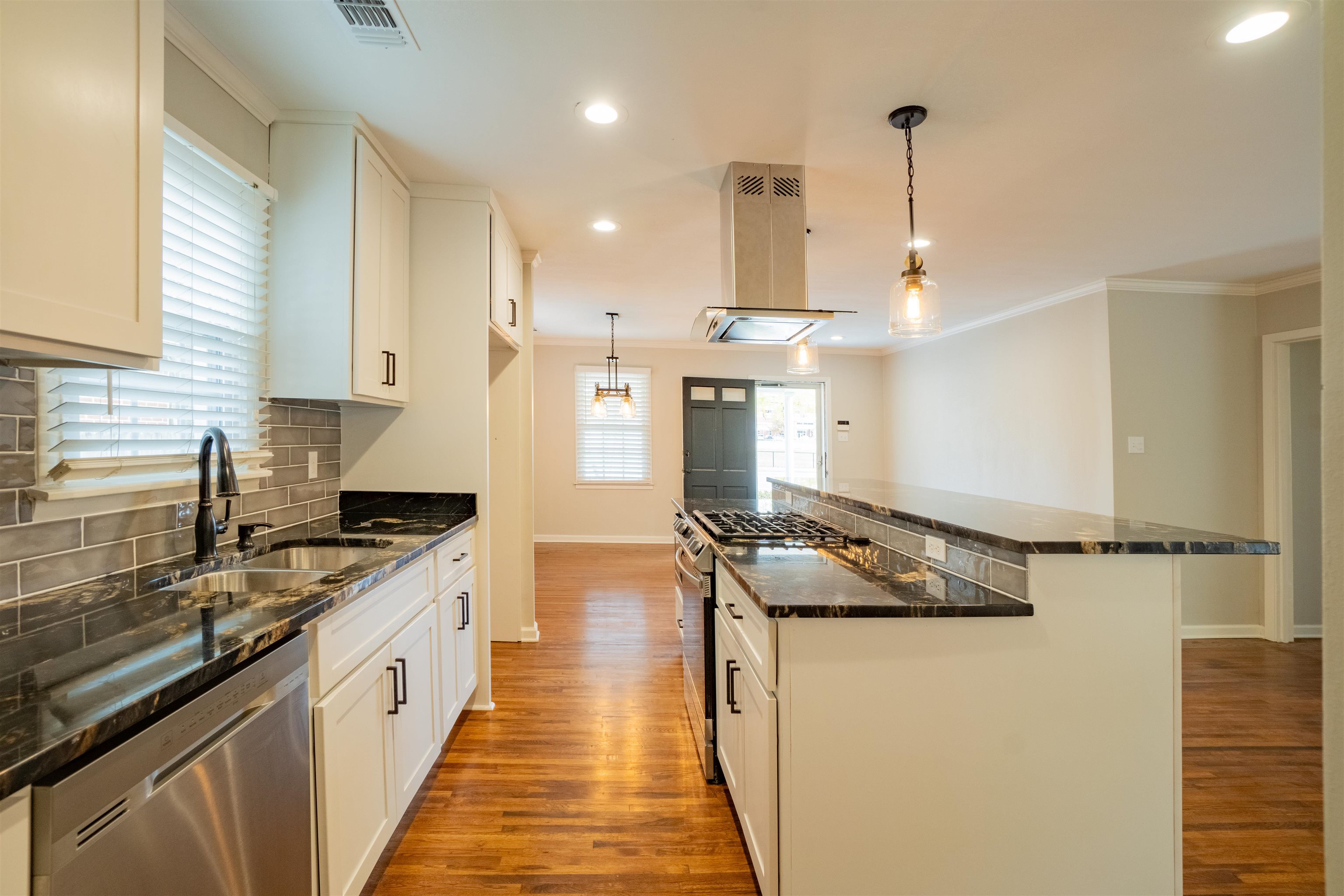 1349 Colonial Road Memphis, TN 38117 - Photo 9 of 29 a kitchen with stainless steel appliances granite countertop a sink stove and refrigerator