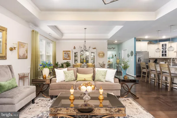 a living room with furniture wooden floor and a table