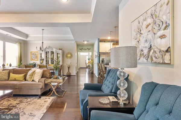 a living room with furniture and a chandelier