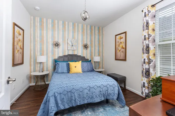 a bedroom with a large bed and a chandelier