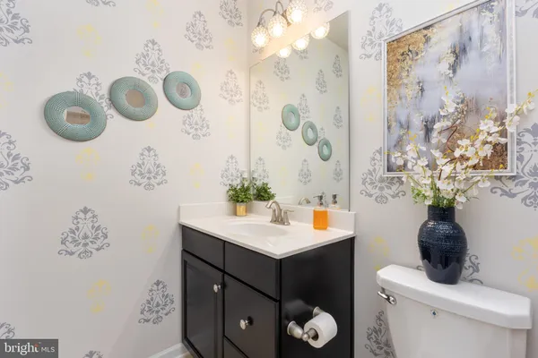 a bathroom with a sink a toilet and shower curtain