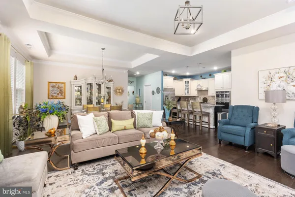a living room with furniture and a view of kitchen