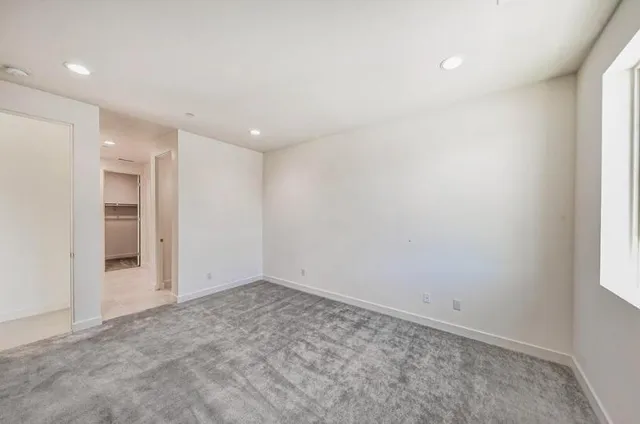 an empty room with a empty space and windows