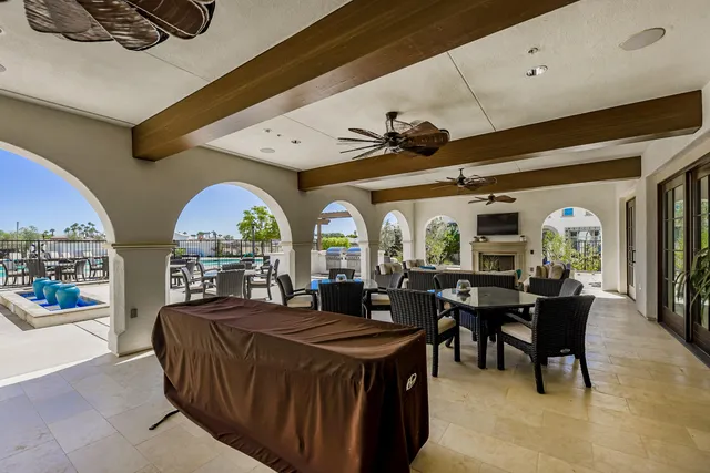 a living room with furniture a fireplace and a large window