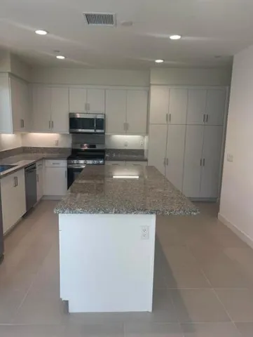 a kitchen with a sink and a refrigerator
