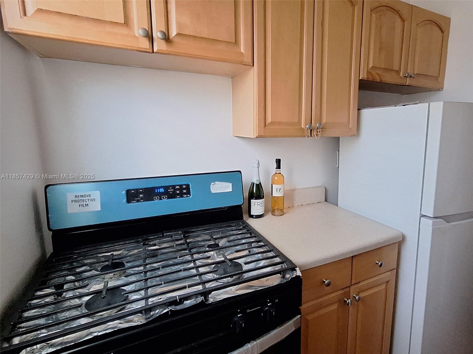 1770 Meridian Avenue, Unit 213 Miami Beach, FL 33139 - Photo 13 of 19 a stove top oven sitting inside of a kitchen