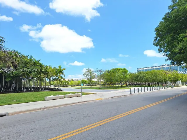 a front view of a house with a yard garden and swimming pool