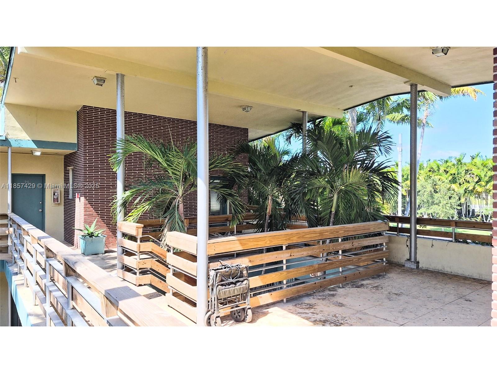 1770 Meridian Avenue, Unit 213 Miami Beach, FL 33139 - Photo 8 of 19 a backyard of a house with plants and outdoor seating