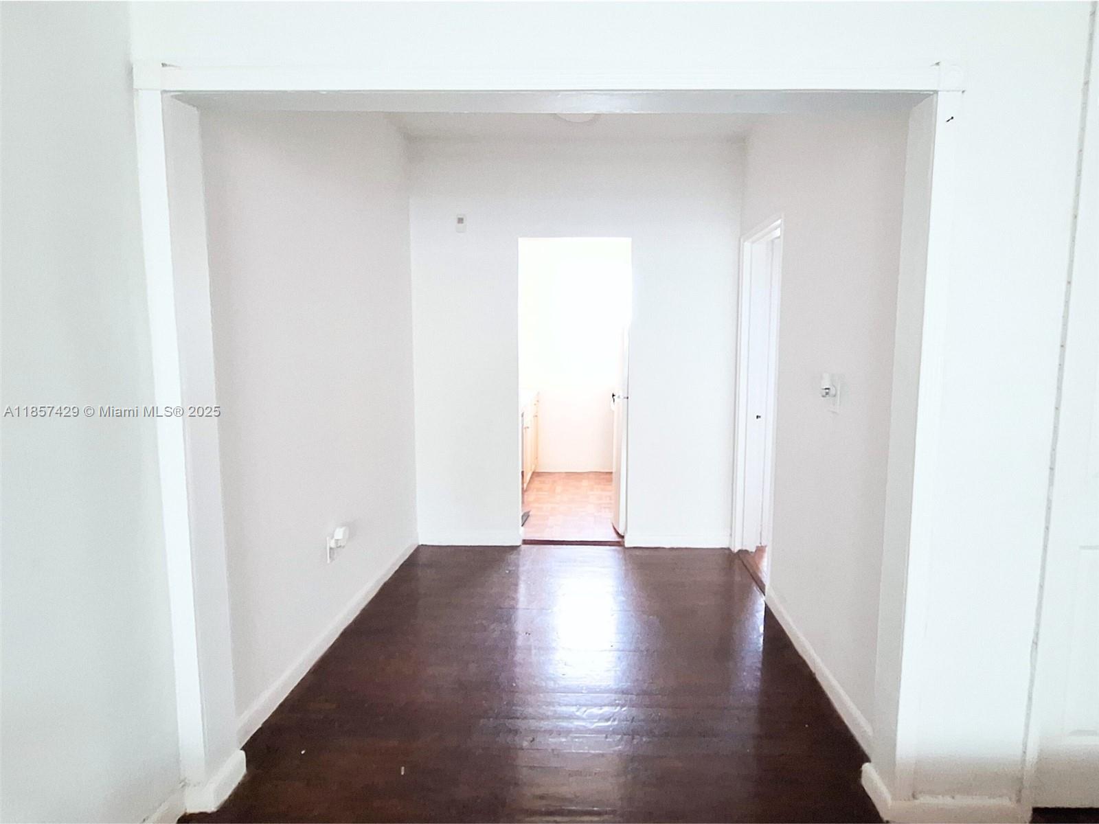 1770 Meridian Avenue, Unit 213 Miami Beach, FL 33139 - Photo 9 of 19 a view of an empty room with wooden floor