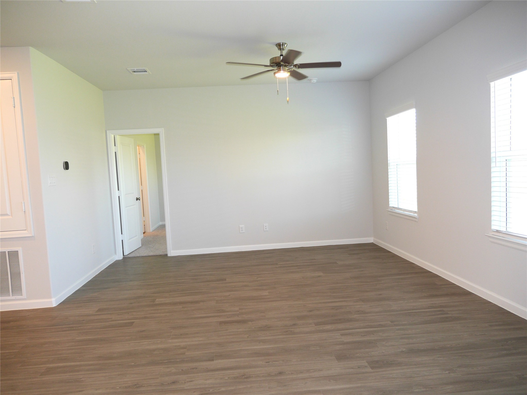 16839 Bristle Cone Way Conroe, TX 77302 - Photo 11 of 22 a view of an empty room with wooden floor and a window