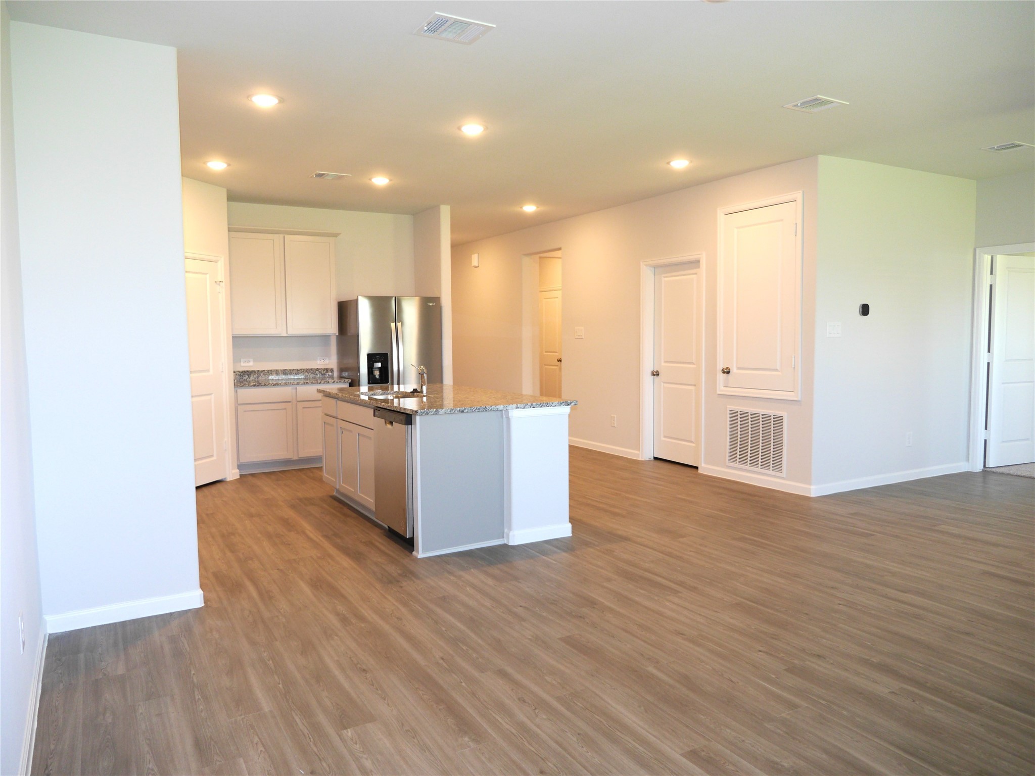 16839 Bristle Cone Way Conroe, TX 77302 - Photo 7 of 22 a view of a kitchen with wooden floor and electronic appliances