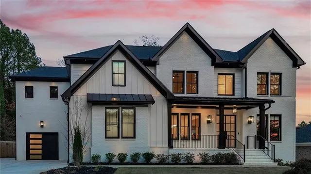 a view of a white house with large windows