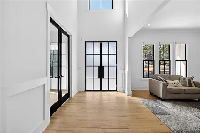 a kitchen with stainless steel appliances granite countertop a sink a stove and a wooden floors