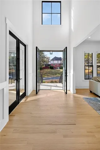 a kitchen with stainless steel appliances granite countertop a sink a stove and a wooden floors