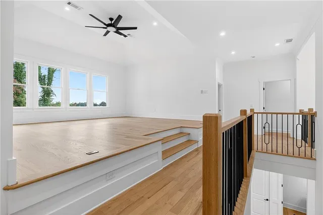 a view of empty room with wooden floor and fireplace