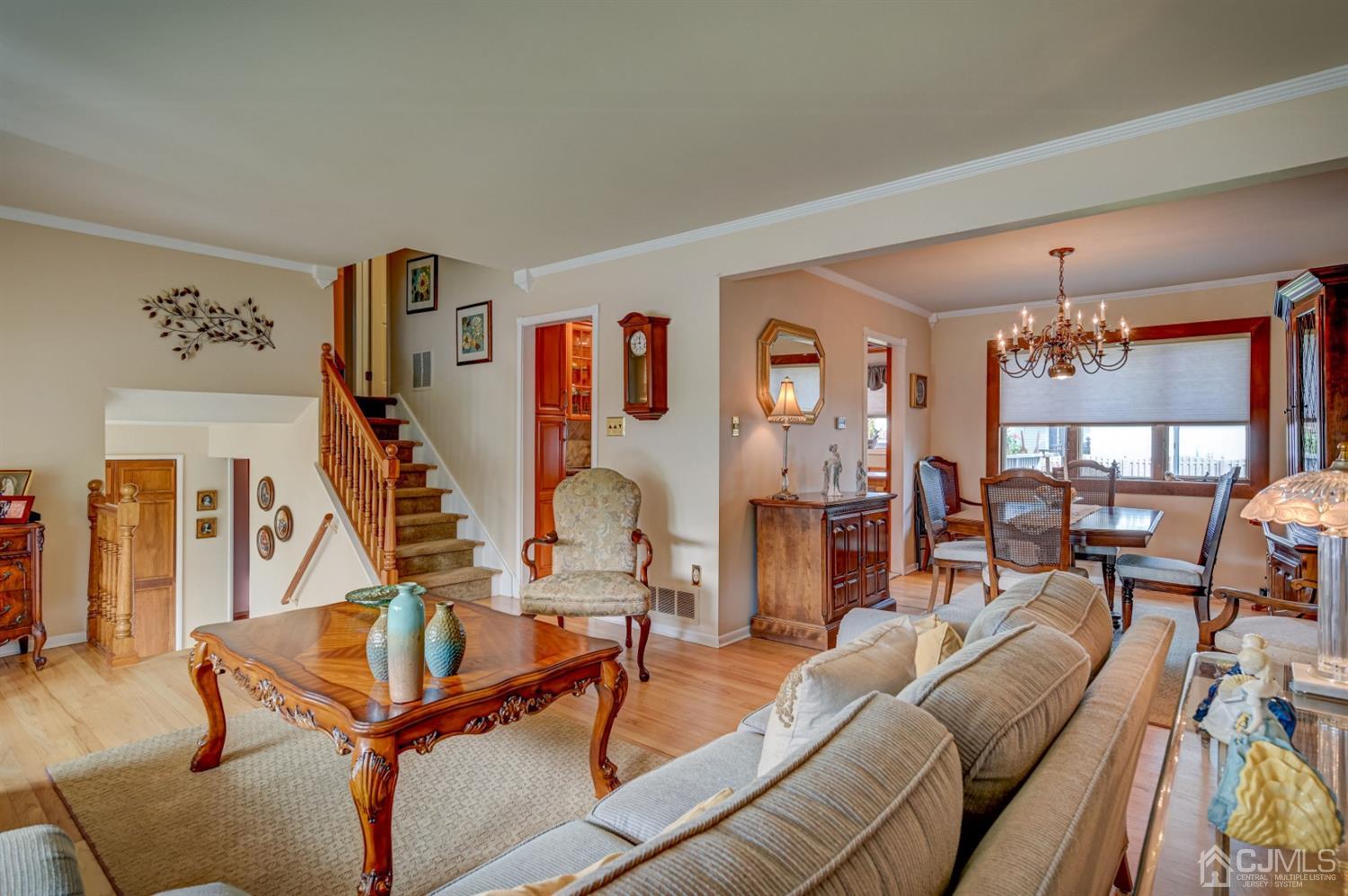 19 Chelsea Road Old Bridge, NJ 08857 - Photo 14 of 34 a living room with furniture a dining table and a chandelier