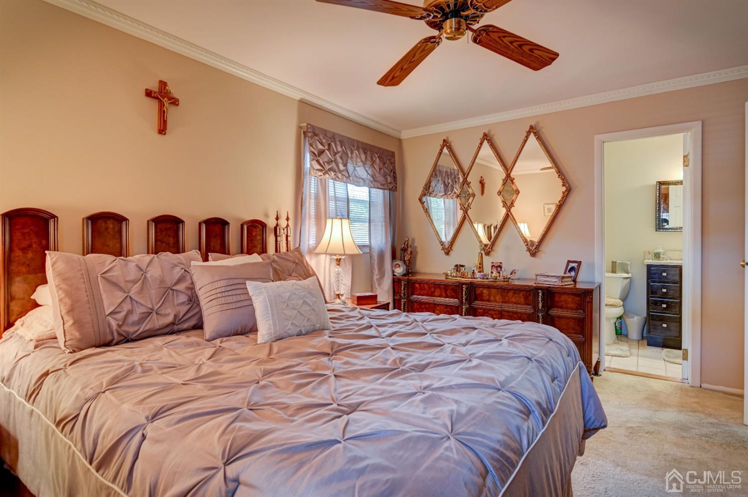 19 Chelsea Road Old Bridge, NJ 08857 - Photo 17 of 34 a bedroom with a large bed and a chandelier