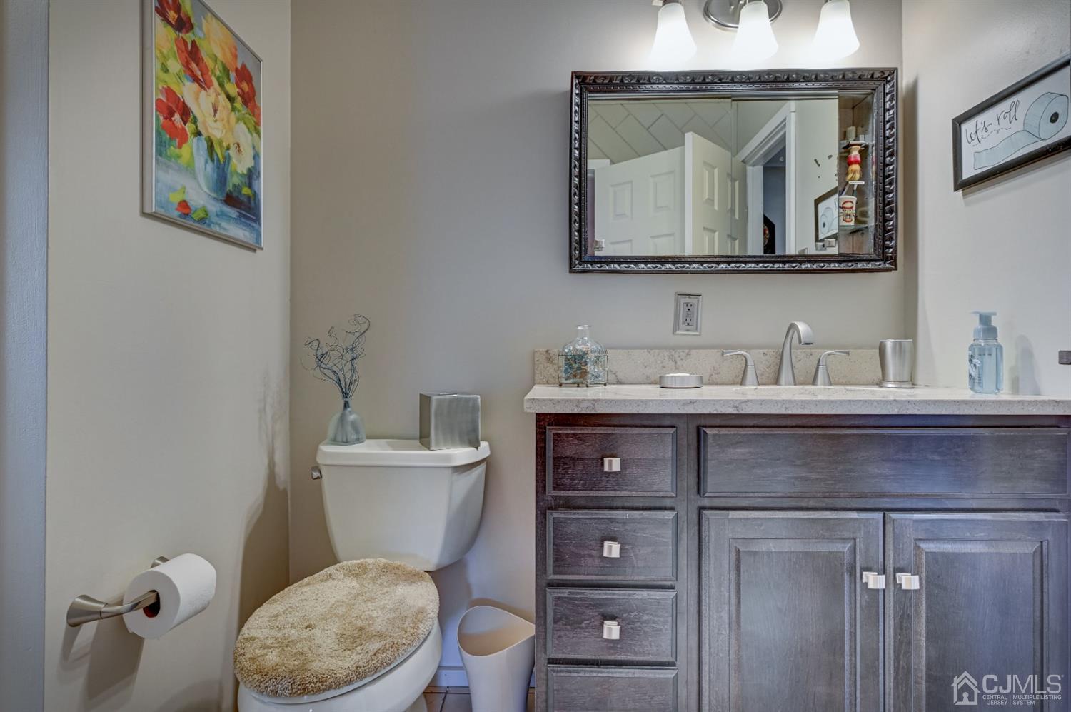 19 Chelsea Road Old Bridge, NJ 08857 - Photo 19 of 34 a bathroom with a toilet a sink and mirror