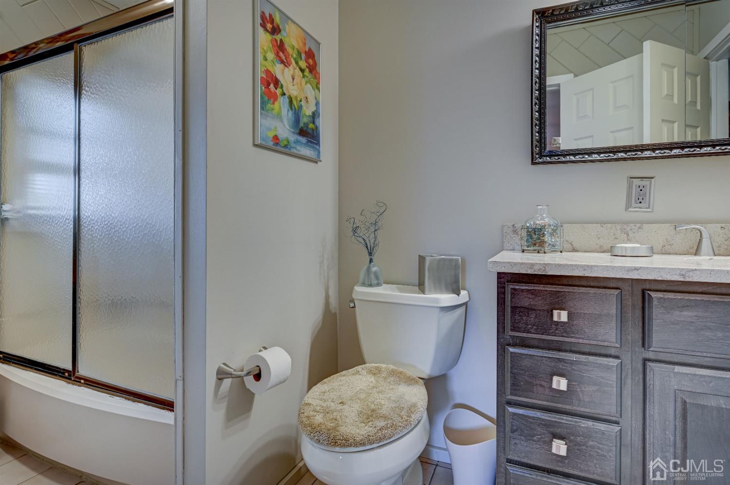 19 Chelsea Road Old Bridge, NJ 08857 - Photo 20 of 34 a bathroom with a toilet a sink and mirror