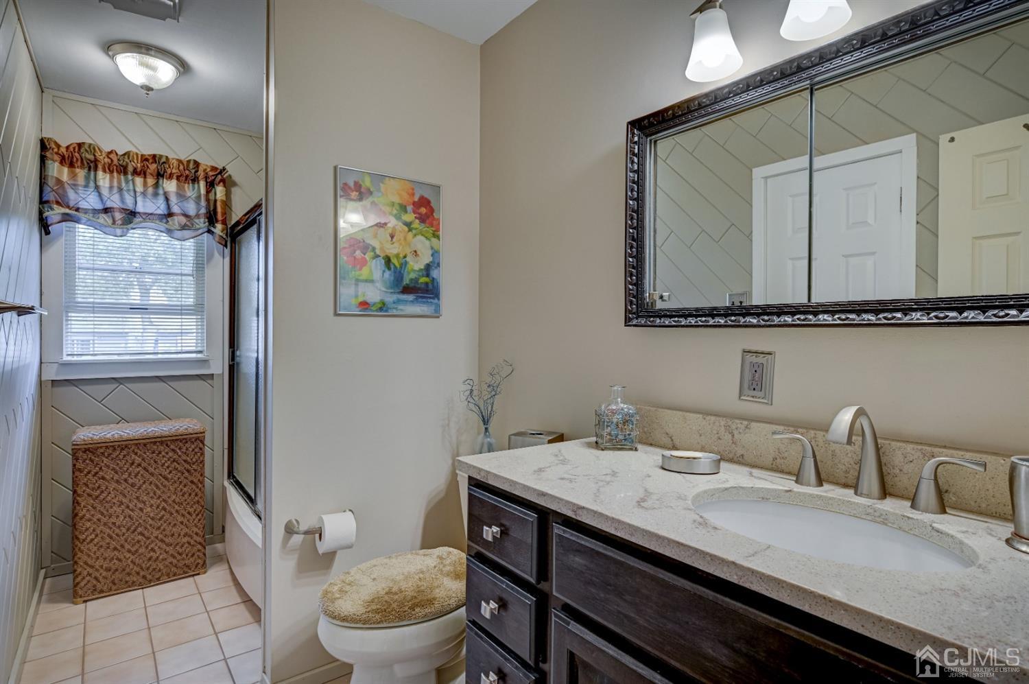19 Chelsea Road Old Bridge, NJ 08857 - Photo 21 of 34 a bathroom with a granite countertop sink a toilet and a mirror