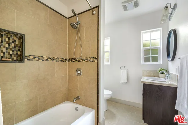 a bathroom with a tub a sink and a shower