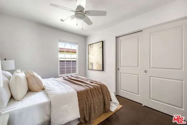 a bedroom with a large bed and a window