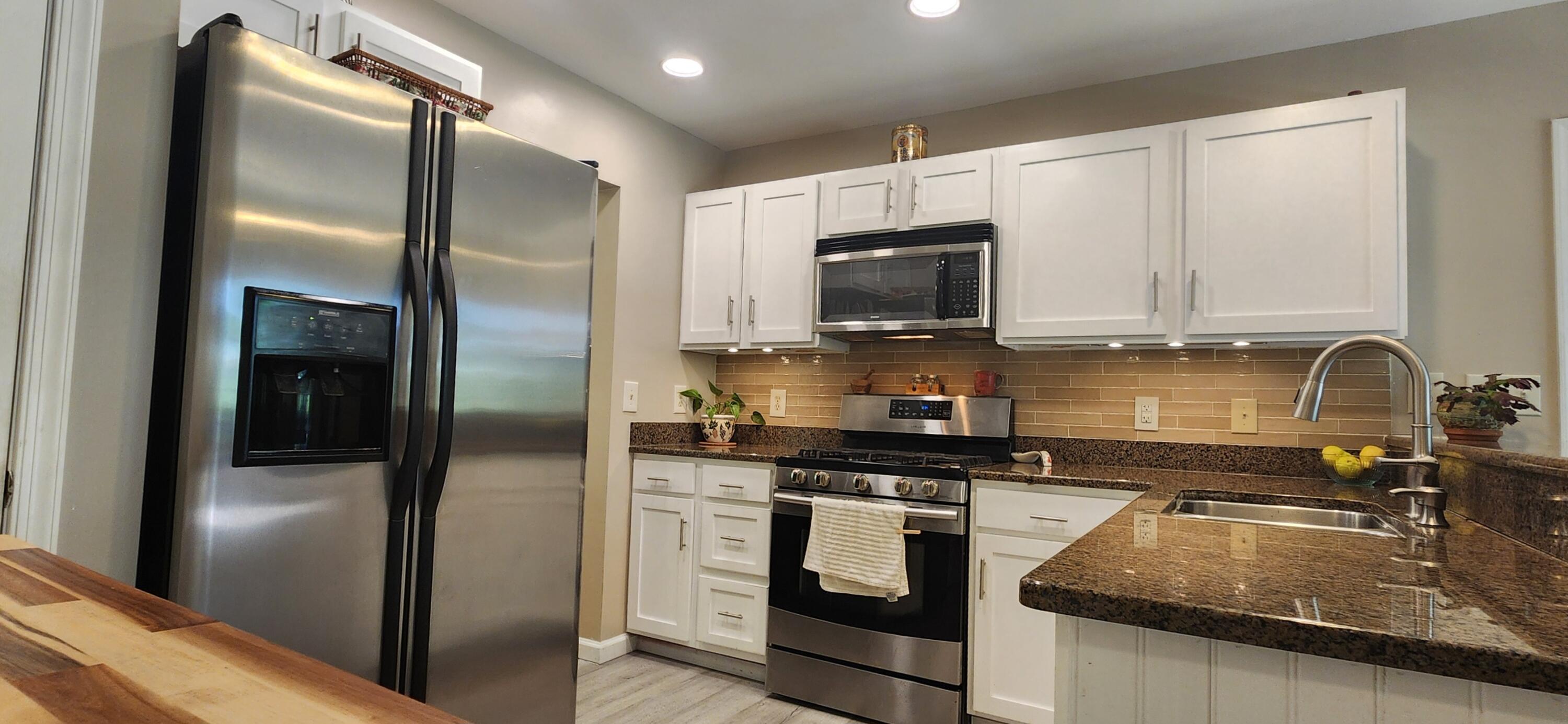 1729 Hemlock Drive Scotrun, PA 18355 - Photo 7 of 21 a kitchen with stainless steel appliances granite countertop a refrigerator a stove and a sink with wooden floor