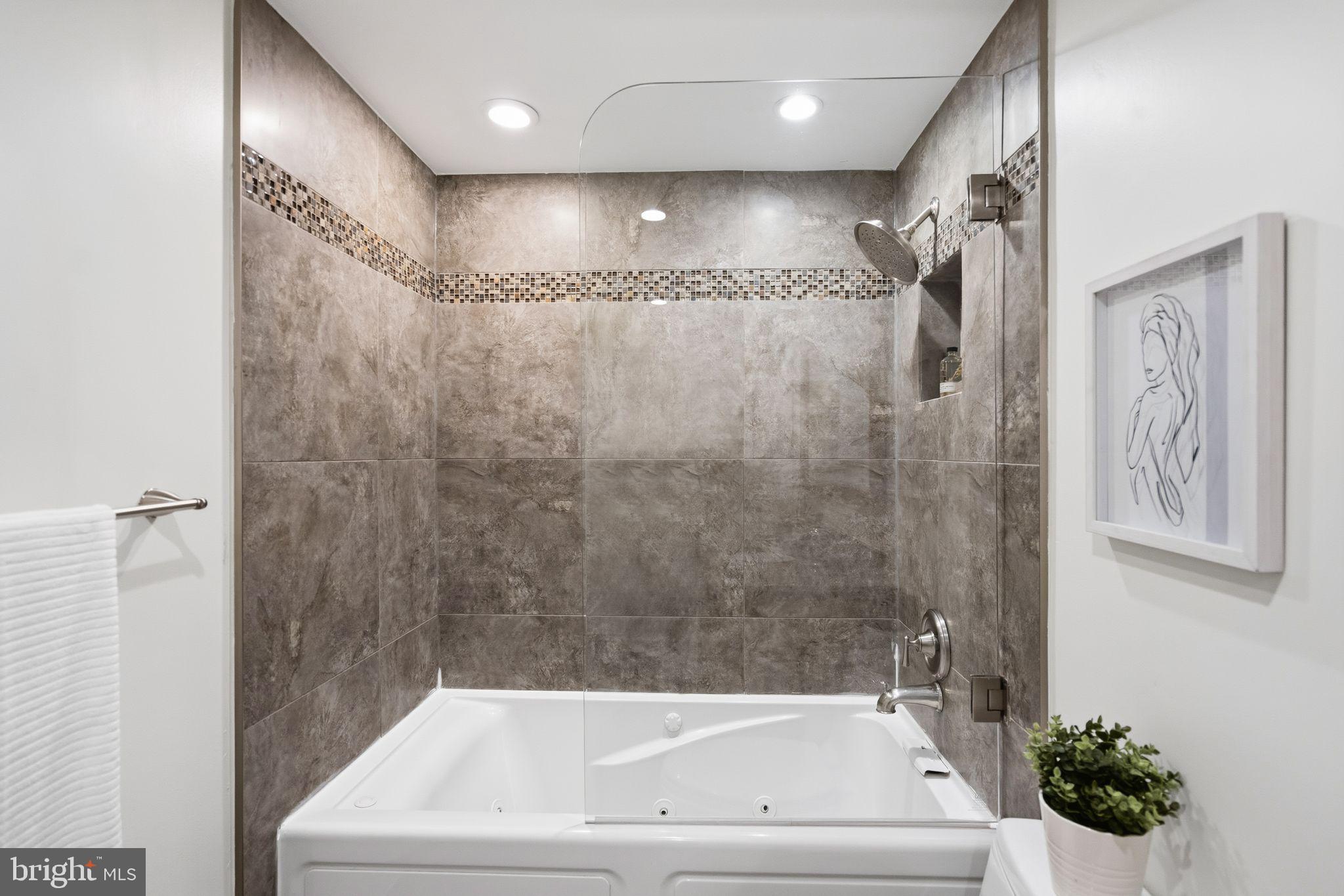 3225 Grace Street Northwest, Unit 226 Washington, DC 20007 - Photo 27 of 45 a bathroom with a bathtub and shower