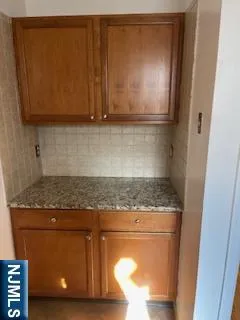 a view of kitchen with granite countertop cabinets