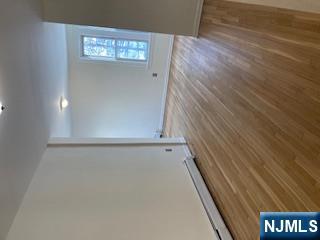 1518 River Road, Unit 3 Edgewater, NJ 07020 - Photo 13 of 19 an empty room with wooden floor and windows