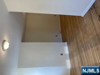 1518 River Road, Unit 3 Edgewater, NJ 07020 - Photo 15 of 19 a view of an empty room with wooden floor and entryway